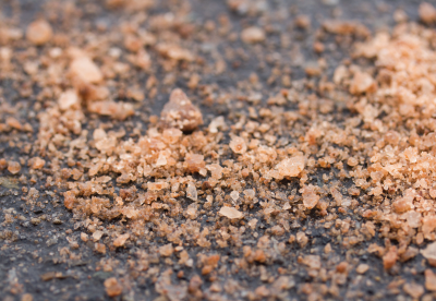 Ice Slicer granular deicer on black asphalt