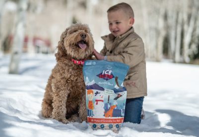 Child and pet dog with a bag of Ice Slicer Nature's Blend